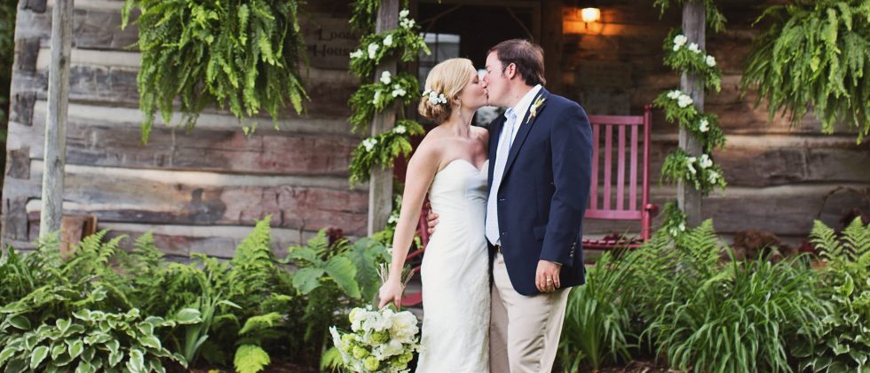 Wedding couple kissing in front of the Loom House